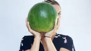 Abbey holding up a large watermelon
